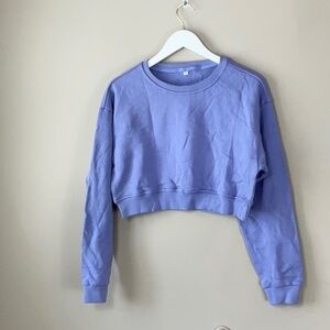 woman’s cropped purple sweatshirt